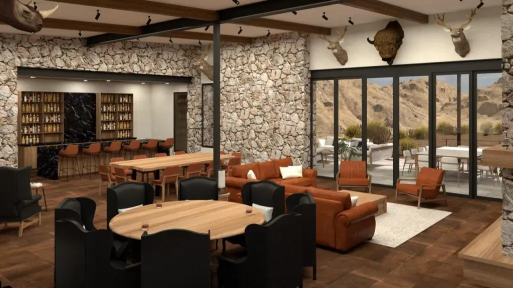 Rancho El Yunque Guest House Interior, a cabin with couches arranged around a coffee table in front of a fireplace